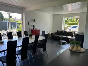a living room with a table and chairs and a couch at Kokhaven 23 in Rødekro