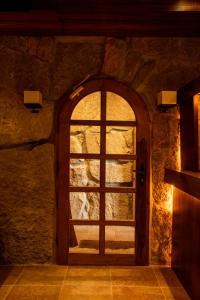a door in a stone room with a window at Terrebrune Hotel in Kfardebian +57 photos