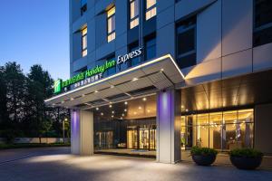 a building with a sign on the front of it at Holiday Inn Express Changfeng Park in Shanghai