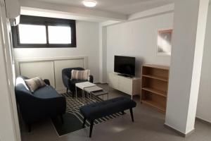 a living room with two chairs and a television at Grande corner villa in Isla Plana by the sea in Isla Plana