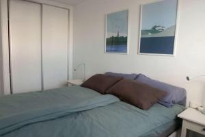 a bed with two pillows on it in a bedroom at Grande corner villa in Isla Plana by the sea in Isla Plana