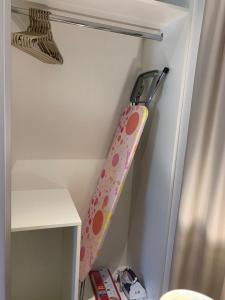 a suitcase hanging on a wall next to a curtain at Lake View Luxury Suite, Hawana Resort in Salalah