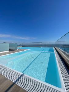 a swimming pool on the roof of a building at Hotel Harmony in Rimini
