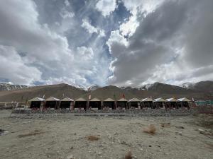 a row of tents with mountains in the background at Padma Cottage Pangong in Spangmik +16 photos