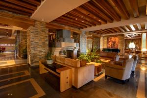 a living room filled with furniture and a fireplace at Terrebrune Hotel in Kfardebian