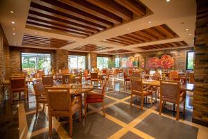 a dining room with wooden tables and chairs at Terrebrune Hotel in Kfardebian