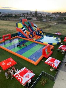a large inflatable play structure in a field at GOLDEN SUN in Vrachati