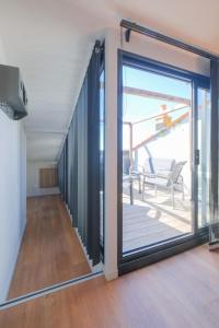 an open sliding glass door in a room with a deck at La Suite Sablaise in Les Sables-dʼOlonne