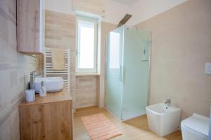 a bathroom with a shower and a sink and a toilet at SeaBreeze Gallipoli - Lido San Giovanni in Gallipoli +23 photos