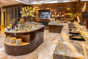a buffet in a hotel with plates of food at Golden Sands Boutique Hotel-Dubai Creek in Dubai