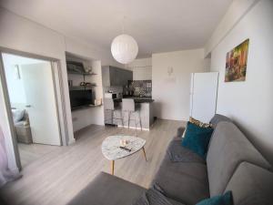 a living room with a couch and a table at Sunorama Beach Garden - Seaview in Larnaca