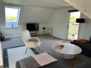 a living room with a couch and a table at Kokhaven 23 in Rødekro