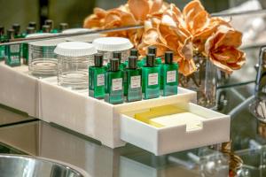 a group of green bottles on a glass table at Golden Sands Boutique Hotel-Dubai Creek in Dubai +37 photos