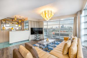 a living room with a couch and a flat screen tv at Golden Sands Boutique Hotel-Dubai Creek in Dubai