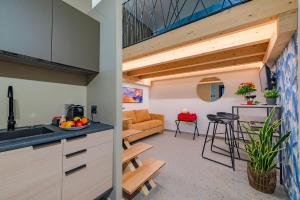 an open kitchen and living room with a loft at Macramè Suites in Sciacca