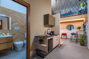 a bathroom with a toilet and a sink at Macramè Suites in Sciacca +122 photos