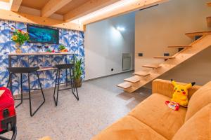a living room with a couch and stairs at Macramè Suites in Sciacca