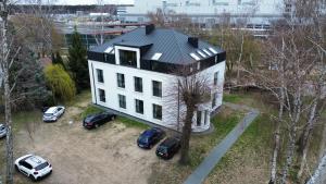 a house with cars parked in front of it at Apartamenty Leszka 2, self check in 24h in Poznań