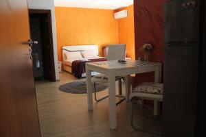 a room with a table with a laptop on it at Apartments Kapisoda in Cetinje