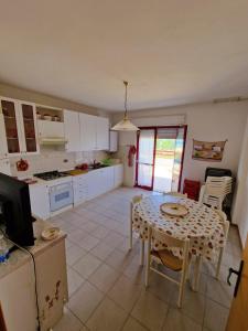 a kitchen with a table and a dining room at Appartamenti Lido Riccio in Ortona