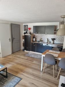 a kitchen and living room with a table and chairs at idylische Ferienwohnung in Schollbrunn