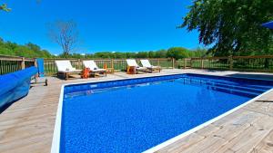 a swimming pool on a deck with lounge chairs next to it at Meadow Sunrise in Bridgman
