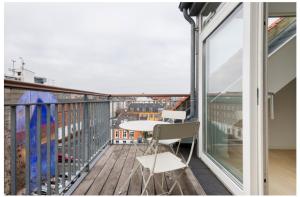 a balcony with a table and a view of a city at Lovely 2-BR apartment in Østerbro - 266 in Copenhagen