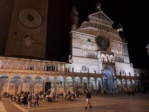 un grande edificio con persone che camminano davanti di B&B La Stazione a Cremona