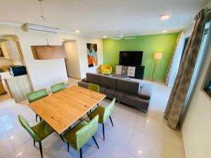a living room with a table and a couch at Apartment Ocean Legend Tamarin in Tamarin