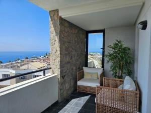 a balcony with a chair and a plant at Villa The Views in Puerto Rico de Gran Canaria