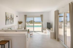 a white living room with a view of the ocean at Villa Lotus - Ionian Villa Collection in Lixouri