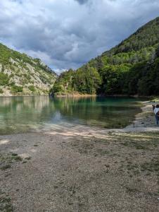 two people standing on the shore of a lake at Hotel il Rifugio del Lupo scanno in Scanno