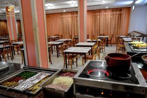 a restaurant with a buffet with tables and chairs at KhimA XL in Hammamet Sud