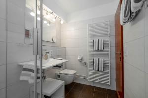 ein weißes Badezimmer mit Toilette und Waschbecken in der Unterkunft Hüs Wüf im Haus Ornum in Westerland + 19 Fotos