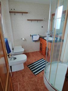 y baño con lavabo, aseo y ducha. en El Rancho Busto - Luarca en Busto