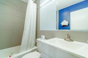 a bathroom with a tub and a toilet and a sink at Budget Inn Frederick US-183 in Frederick +123 photos