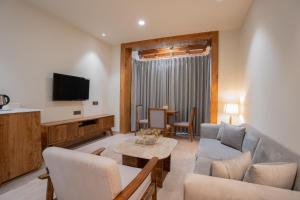 a living room with a couch and a table at The Highland Ladakh in Leh +16 photos
