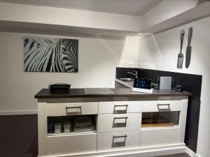 a kitchen with a counter with a laptop on it at Apartelliment - smart übernachten in Köln in Cologne