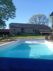 a large swimming pool in front of a house at Alpagas de Barres in Sénaillac-Latronquière