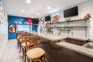 a bar in a restaurant with wooden stools at Microtel Inn & Suites by Wyndham Brooksville in Ridge Manor