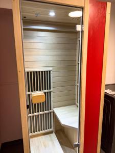 a walk in shower in a room with a sauna at Apartelliment - smart übernachten in Köln in Cologne