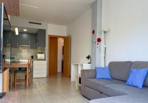 a living room with a couch and a kitchen at Apartment Marina in Vilanova i la Geltrú