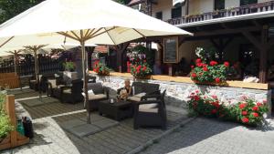 a person sitting under an umbrella at a restaurant at U Královny Dagmar in Karlštejn