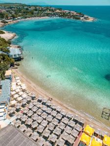 an aerial view of a beach with umbrellas and the ocean at Lotus City Sığacık in Seferihisar