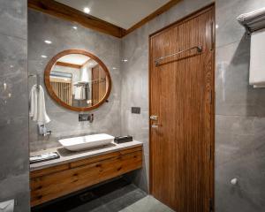 a bathroom with a sink and a mirror at The Highland Ladakh in Leh