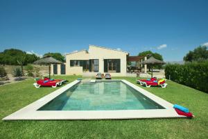 a swimming pool in the yard of a house at Villa Figueral by Villa Plus in Alcudia