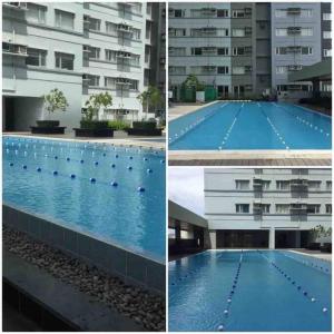 a large swimming pool in front of a building at Loft-Style Condo @ Avida Towers with Wifi in Davao City