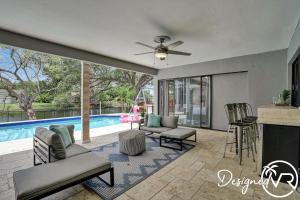 a living room with a ceiling fan and a pool at Perfect for Family 6 Br w POOL & Lake access in Plantation