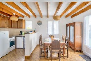 een keuken met een tafel en stoelen in een kamer bij Plage et decouverte de la Bretagne in Plobannalec-Lesconil
