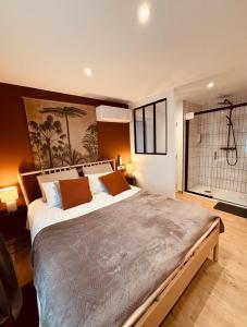 een slaapkamer met een groot bed en een douche bij Le gite des 3 mousquetaires in Amboise